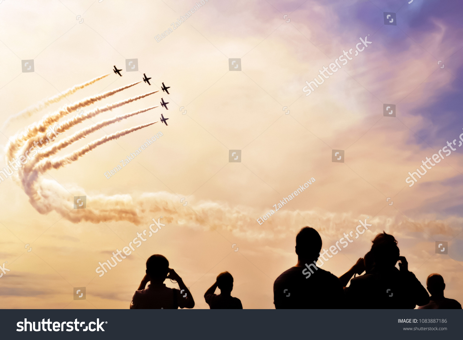 A group of professional pilots of military aircraft shows tricks in the evening sky, leaving beautiful traces of clouds. International Aviation and Space Salon, MAKS. Zhukovsky, Moscow Region, Russia. #1083887186
