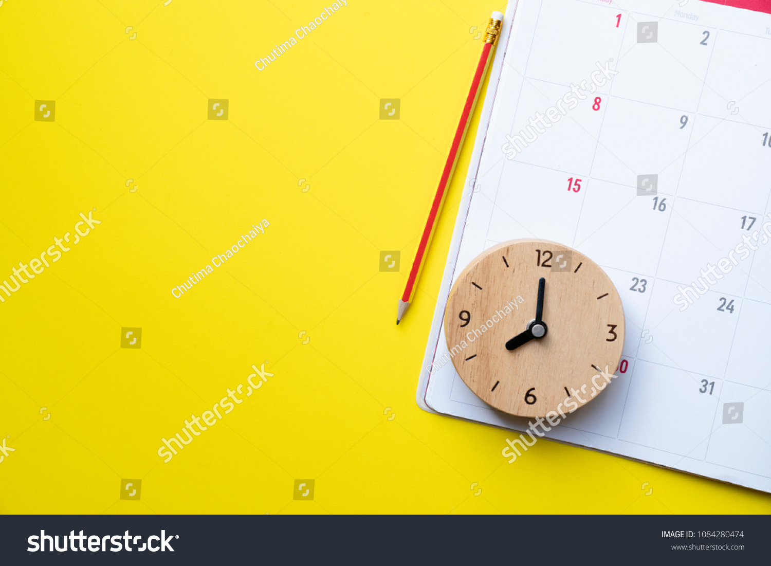 close up of calendar or monthly planner on the yellow background, planning for business meeting or travel planning concept #1084280474