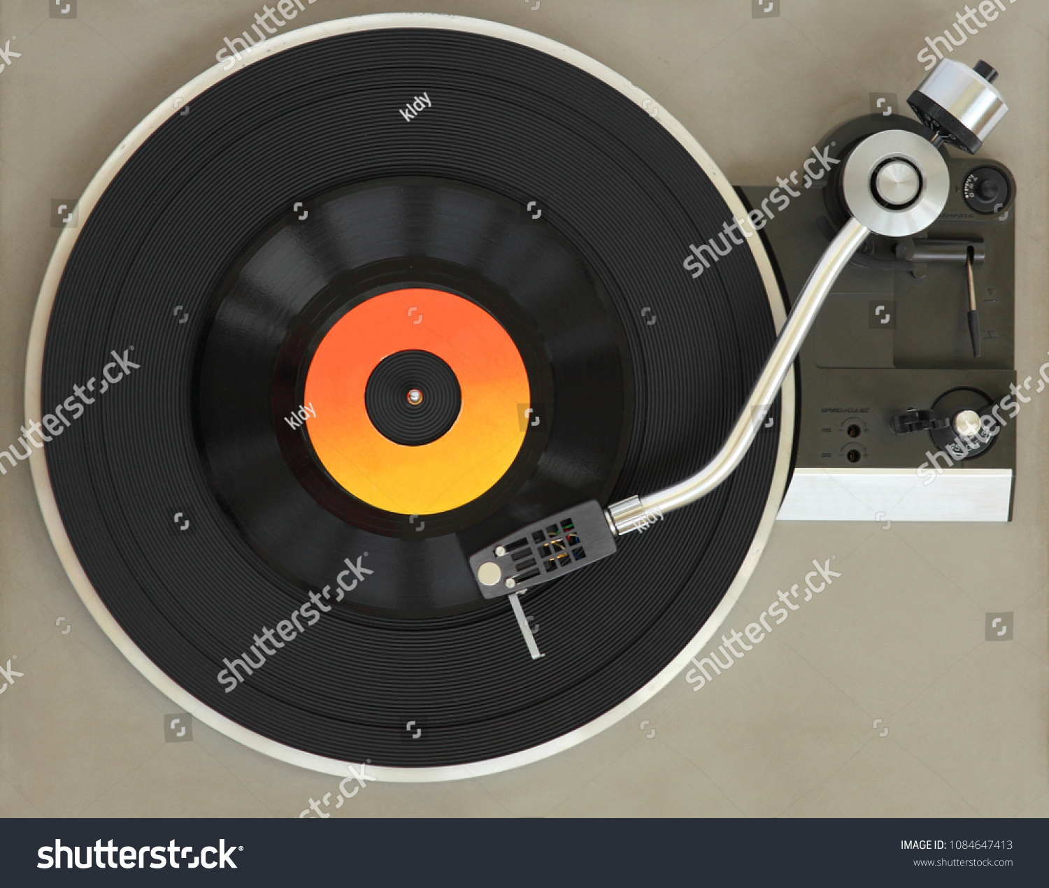 Vintage record player with vinyl record.  #1084647413