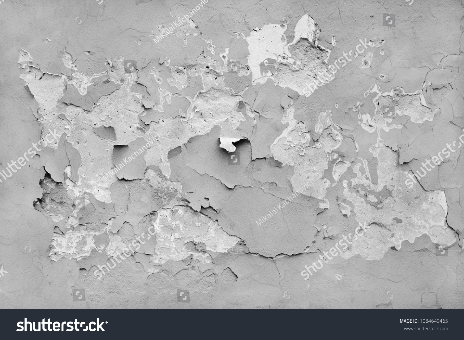 Flaking paint on an old concrete wall. Gray background. Texture. #1084649465