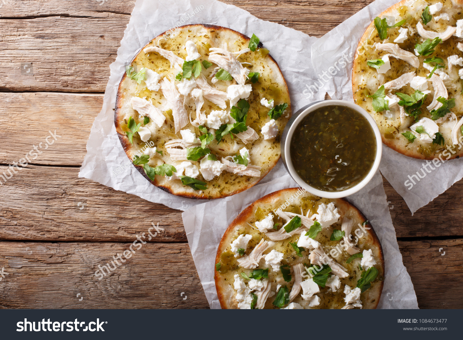 Mexican Chalupas with cheese and chicken meat and sauce salsa verde closeup on a table horizontal top view from above
 #1084673477
