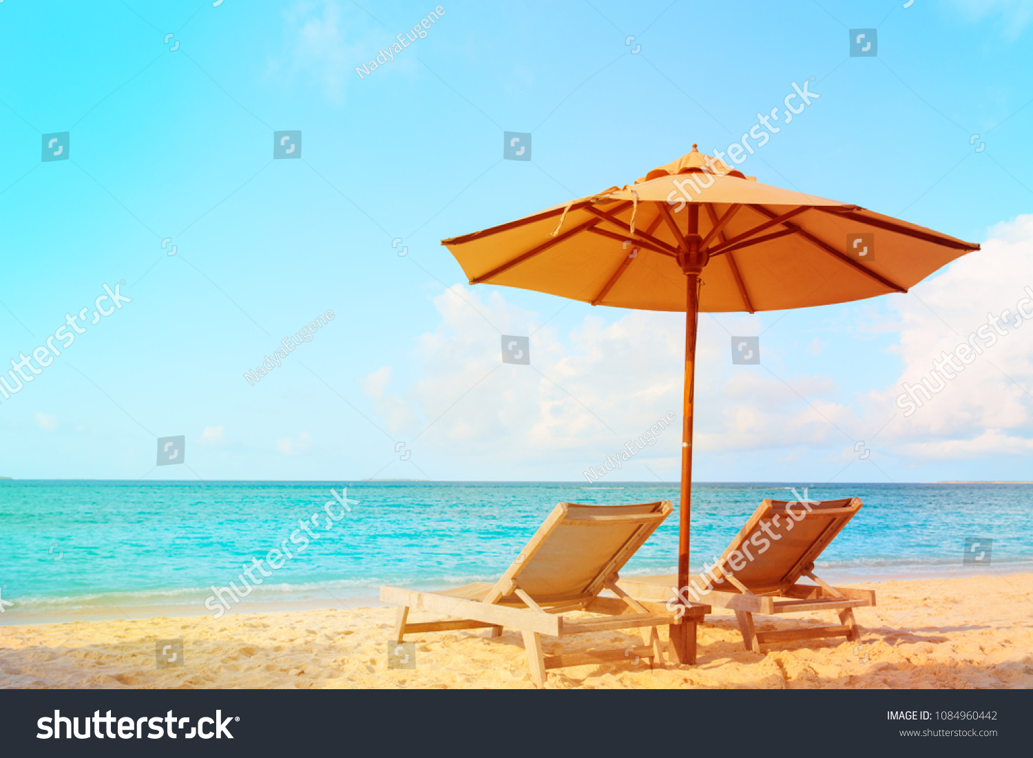 Two beach chairs on tropical vacation #1084960442