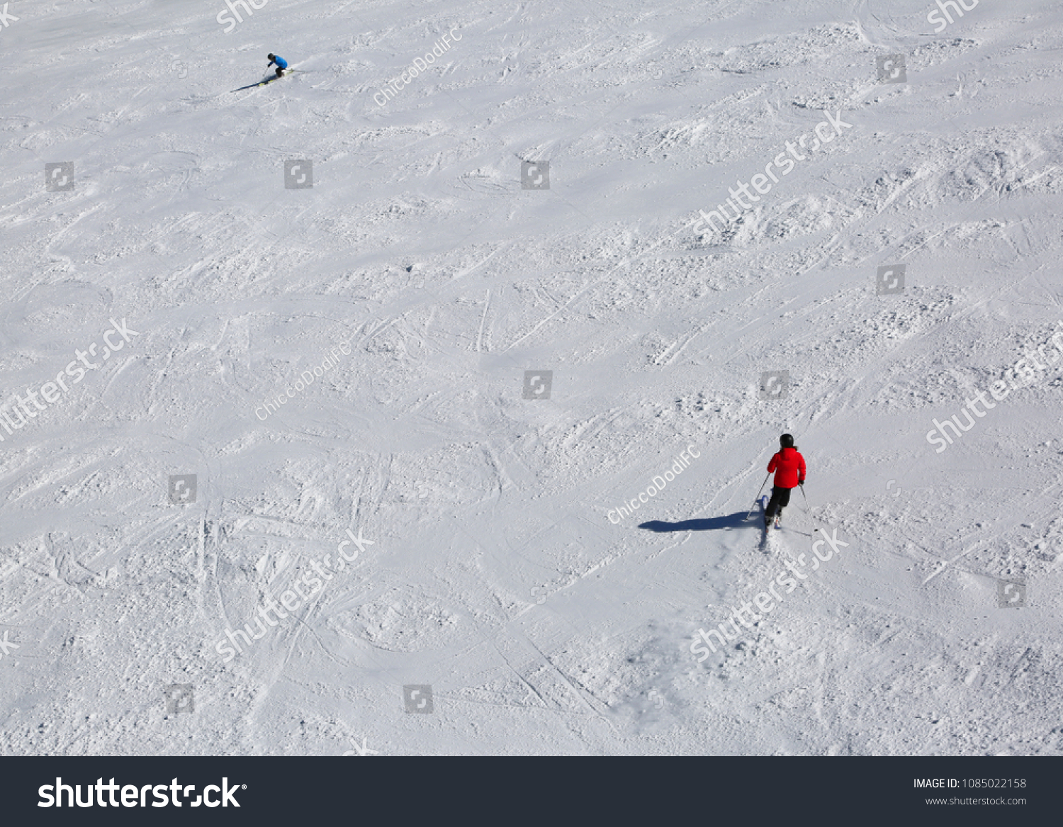 skiers in the slope with snow #1085022158