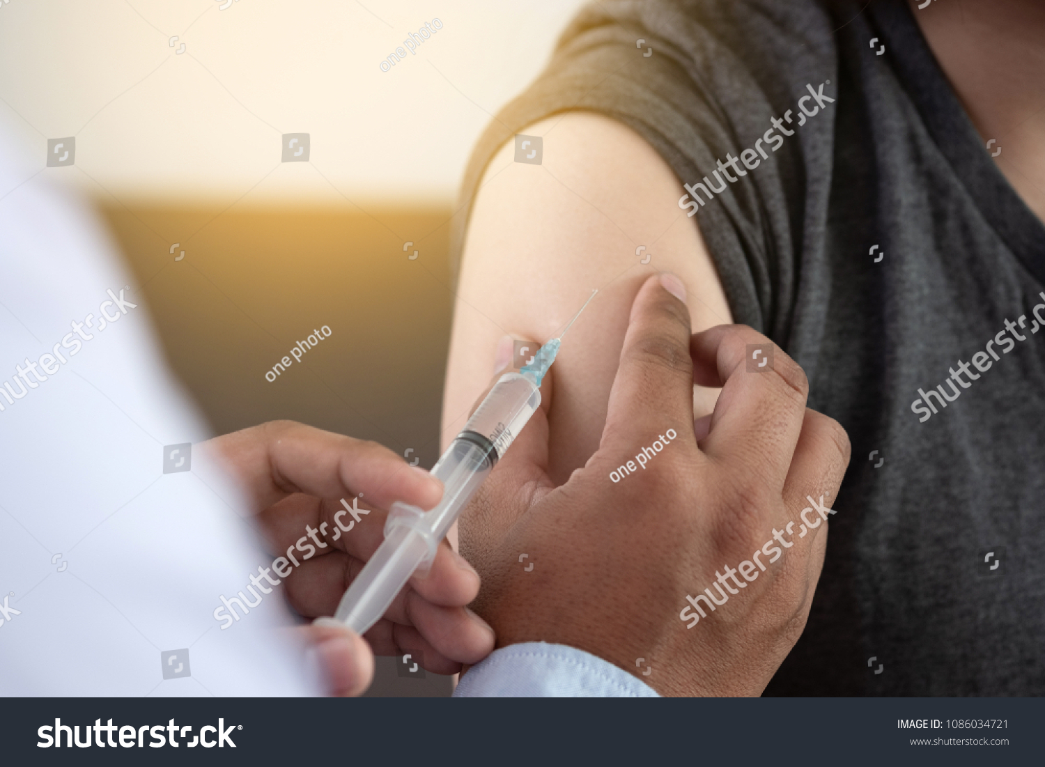 Medicine and health care concept Doctor giving patient vaccine insulin or vaccination #1086034721