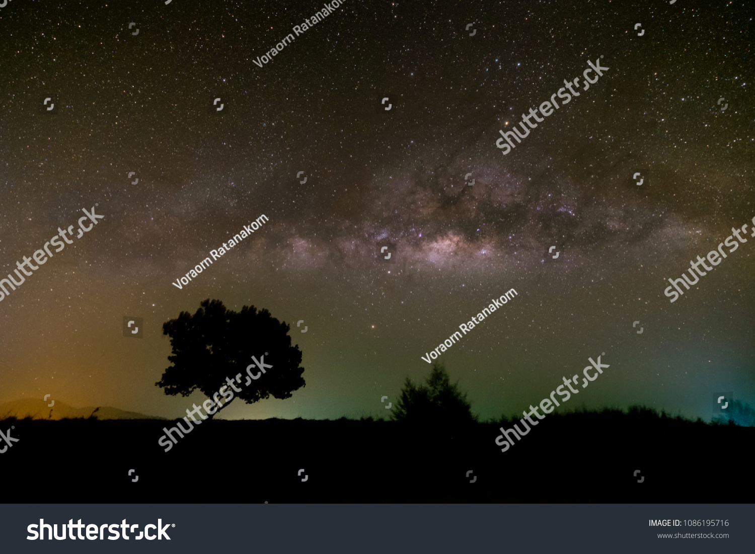 Milky way galaxy brightening in the night sky over the mountain. #1086195716