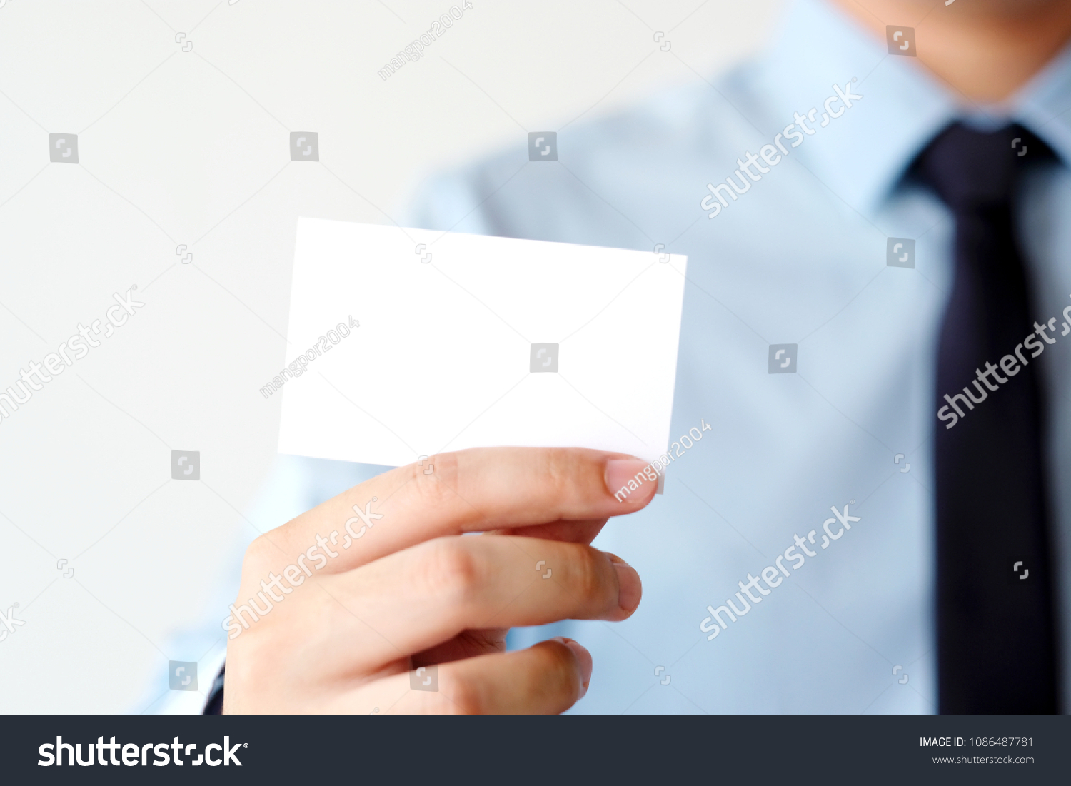 Businessman hand holding blank white business card with copy space for text, business mock up background concept  #1086487781