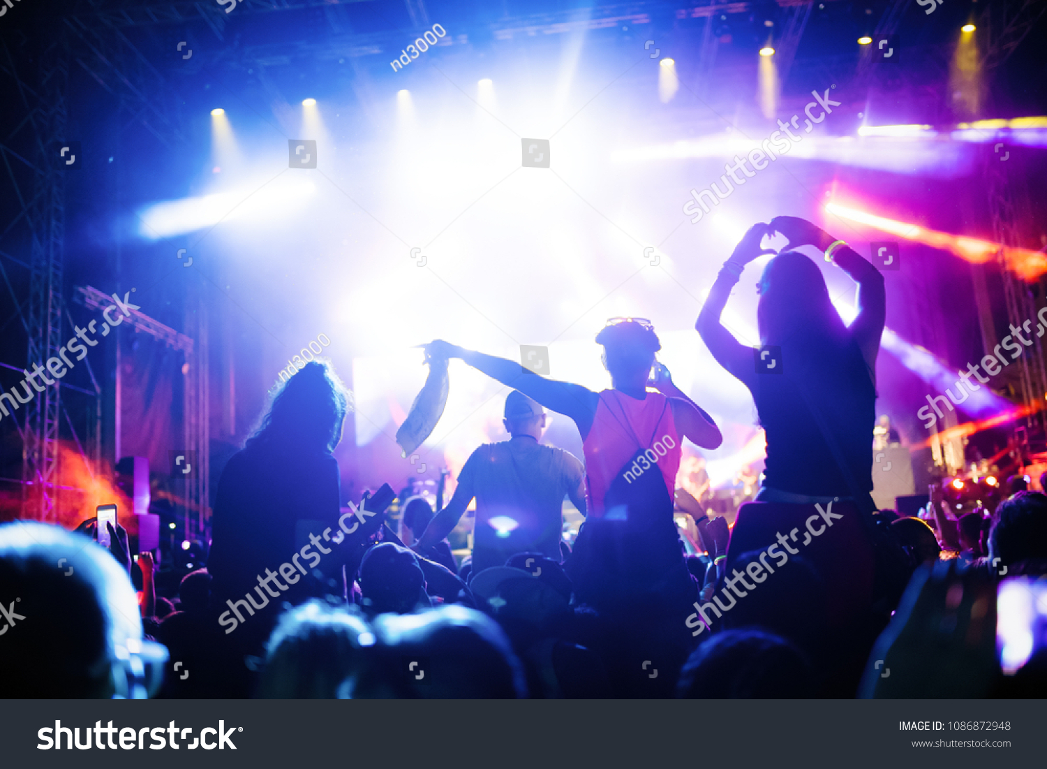 Portrait of happy crowd enjoying at music festival #1086872948