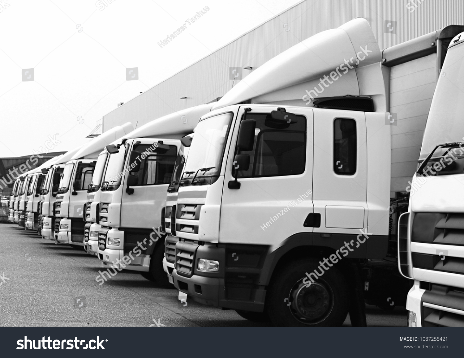 lorries parked up outside a company's car parking area no people stock photo #1087255421