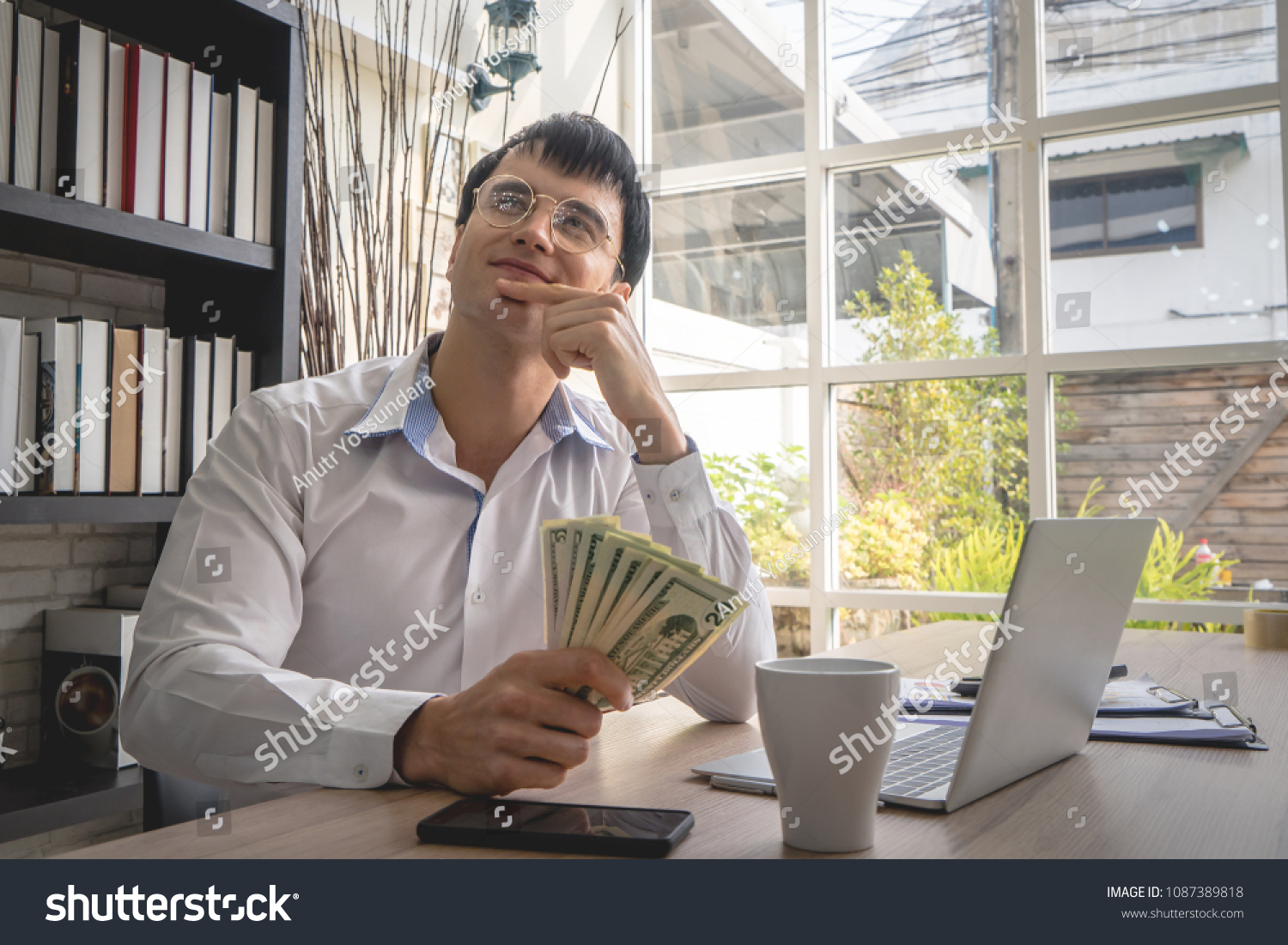Business man is dreaming of more money working online #1087389818