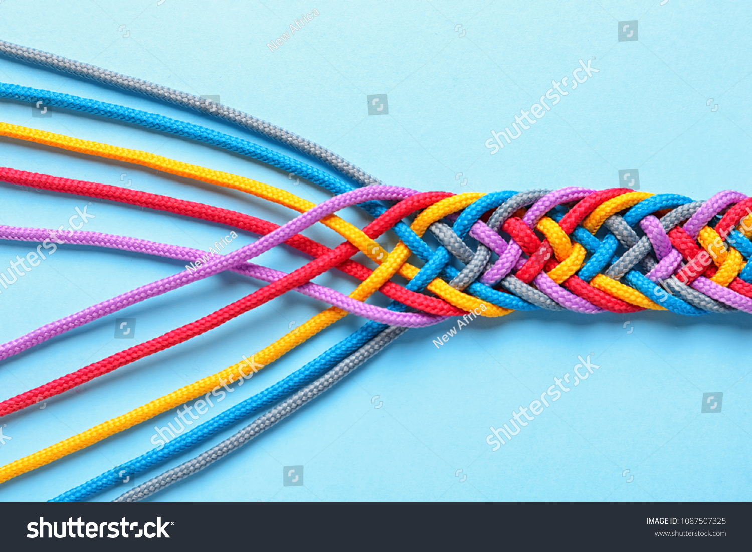Braided ropes on color background, top view. Unity concept #1087507325