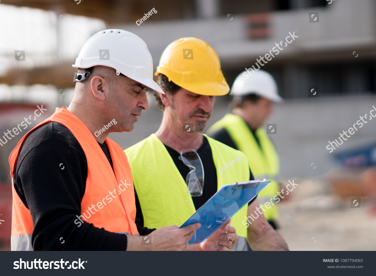Civil engineers and construction workers at work on construction site #1087794065