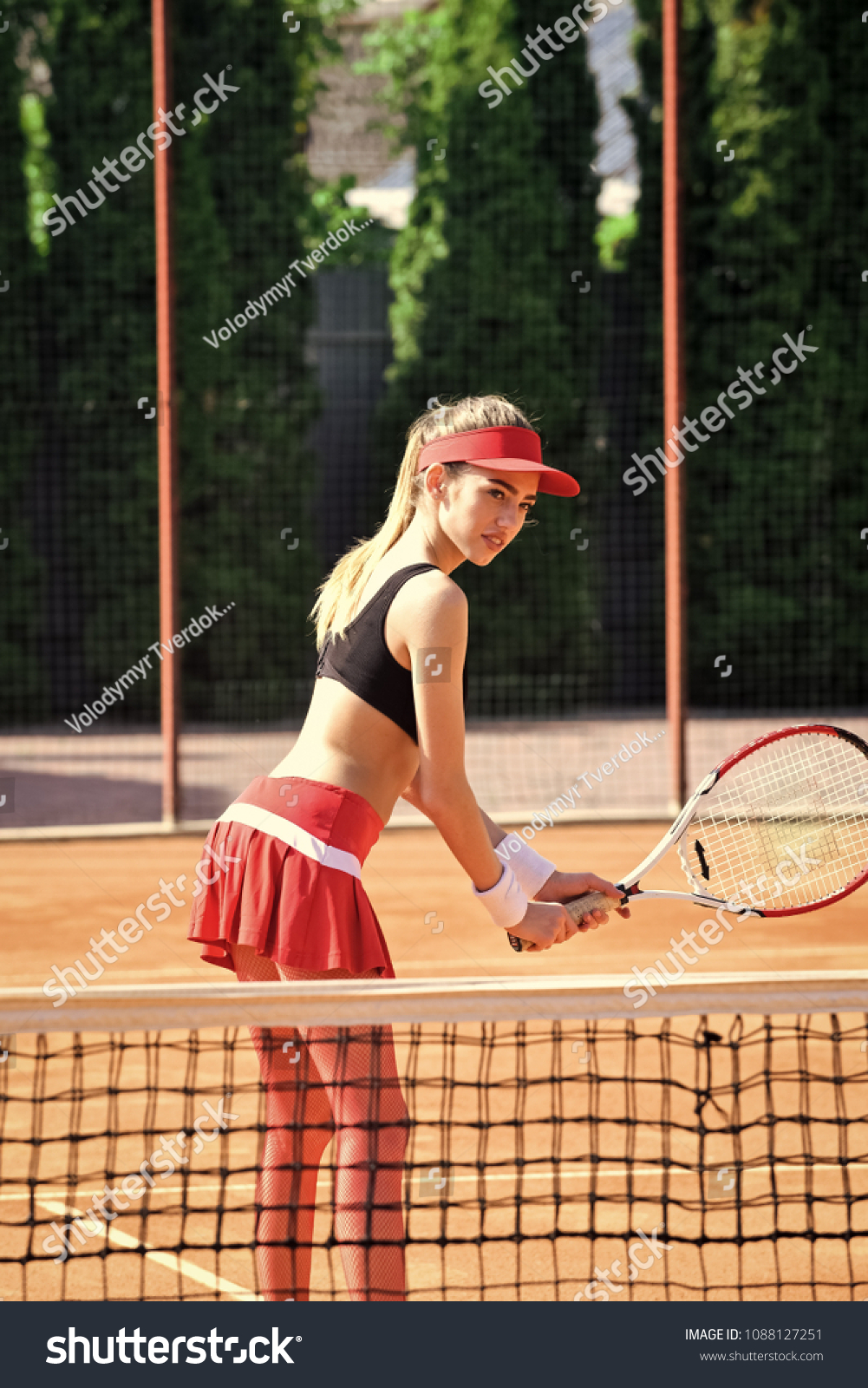 Woman with tennis racket at net on lawn, activity. Sensual woman play tennis on court, sport. Activity, energy, power. Sport, training, workout. Wellness, bodycare, health. #1088127251