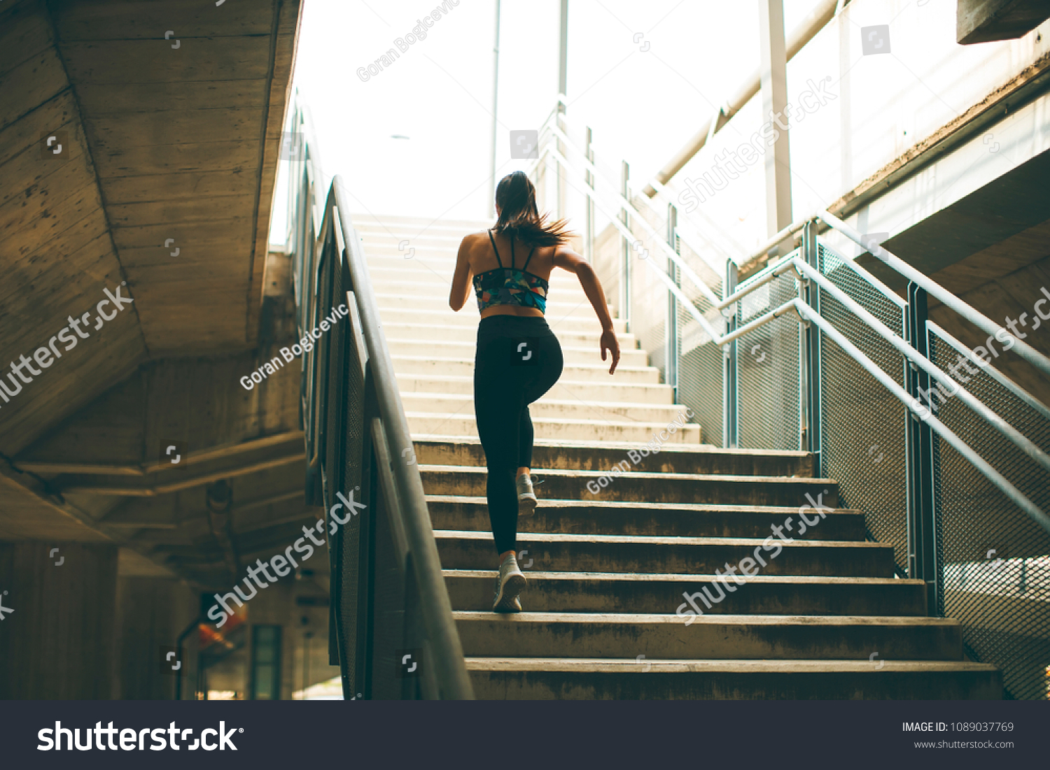 Young woman running alone up stairs  outdoor #1089037769