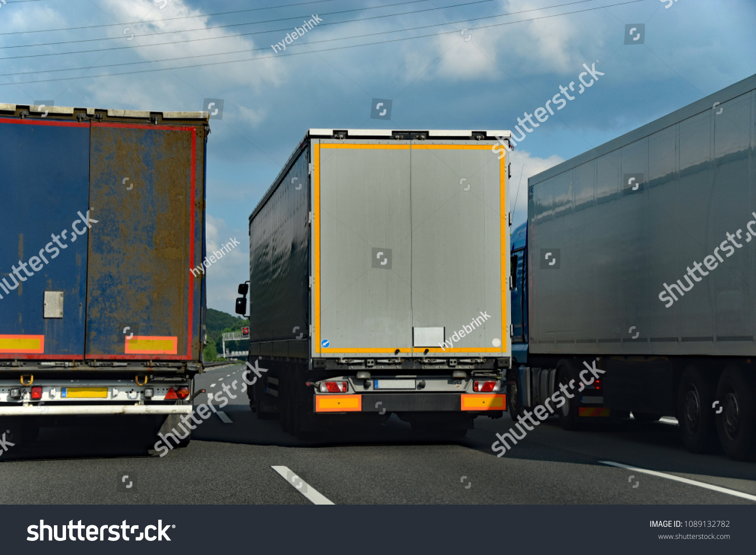 Three trucks in a dangerous overtaking maneuver #1089132782