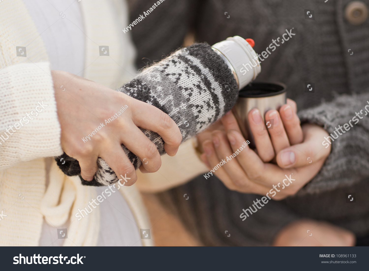 woman pours tea from a thermos. #108961133