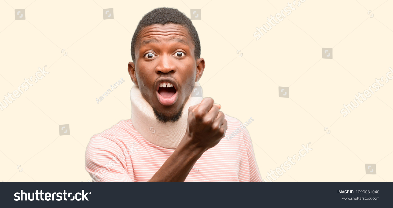 Injured african black man wearing neck brace irritated and angry expressing negative emotion, annoyed with someone #1090081040