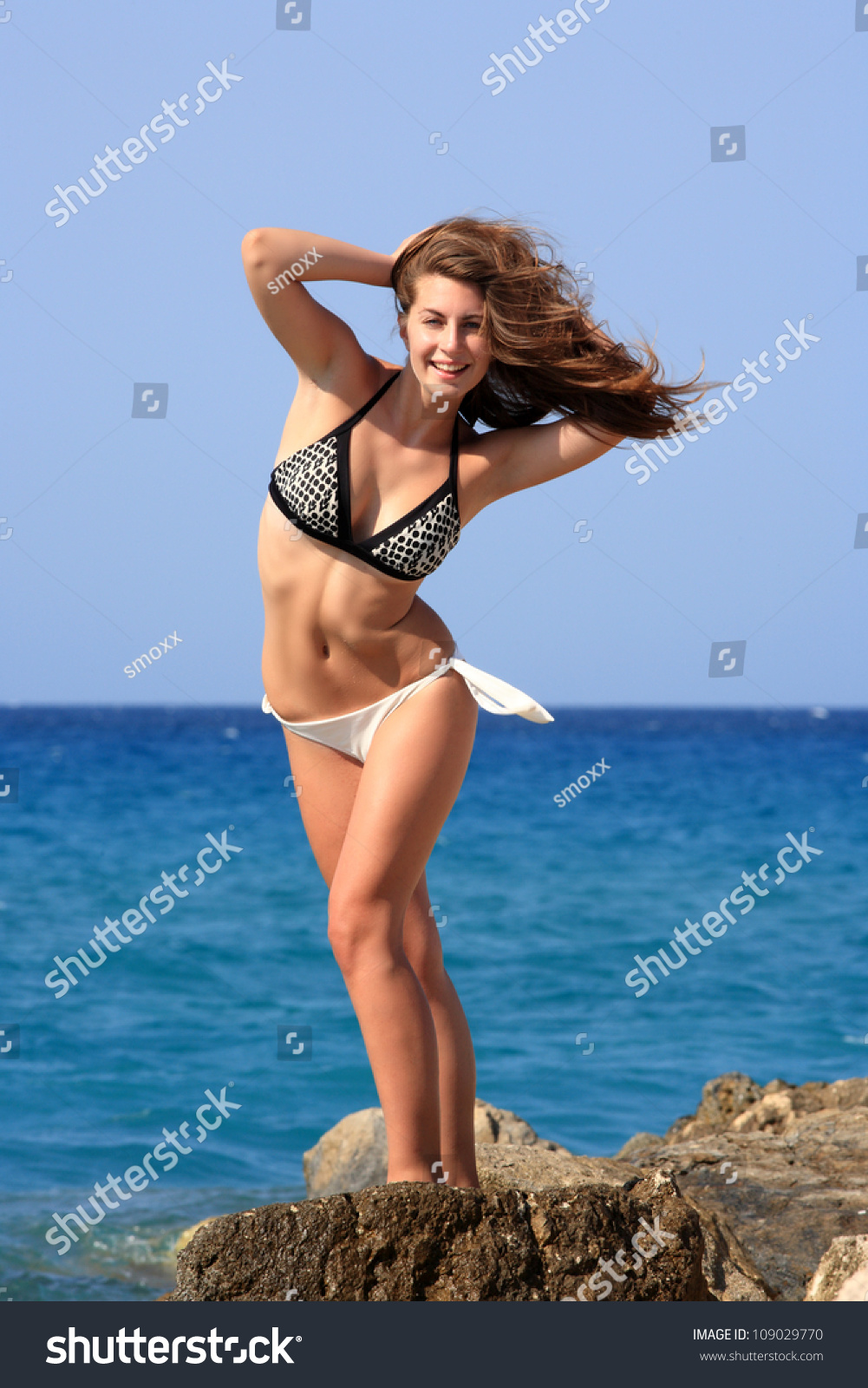 portrait of a beautiful young girl with bikini at the beach #109029770