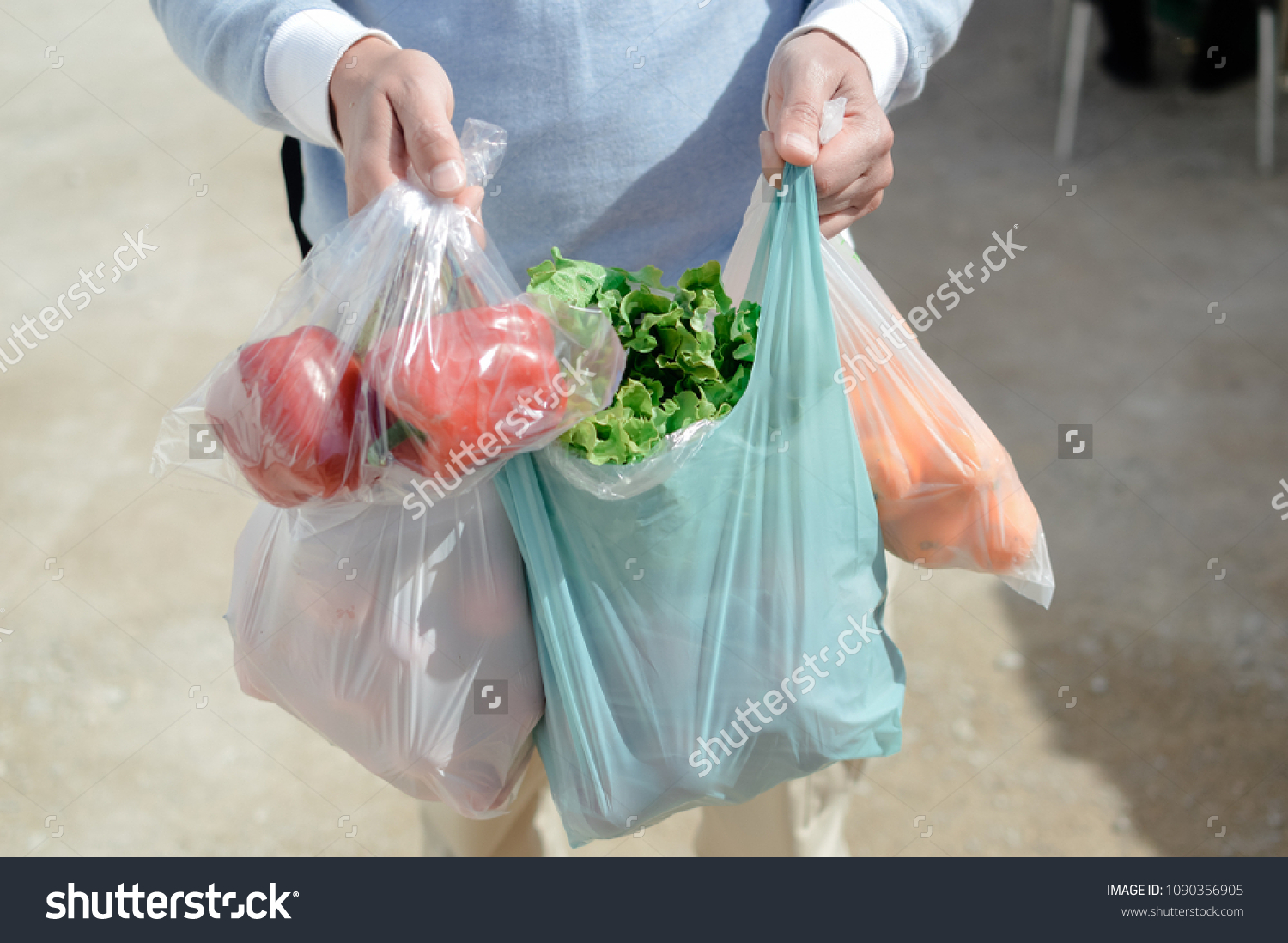 Close up on person buyer hold groceries in bags. Buy sell vegetables. Healthy wellbeing lifestyle background #1090356905