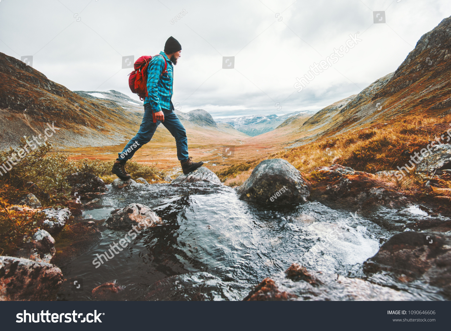 Man solo traveling backpacker hiking in scandinavian mountains active healthy lifestyle adventure journey vacations #1090646606