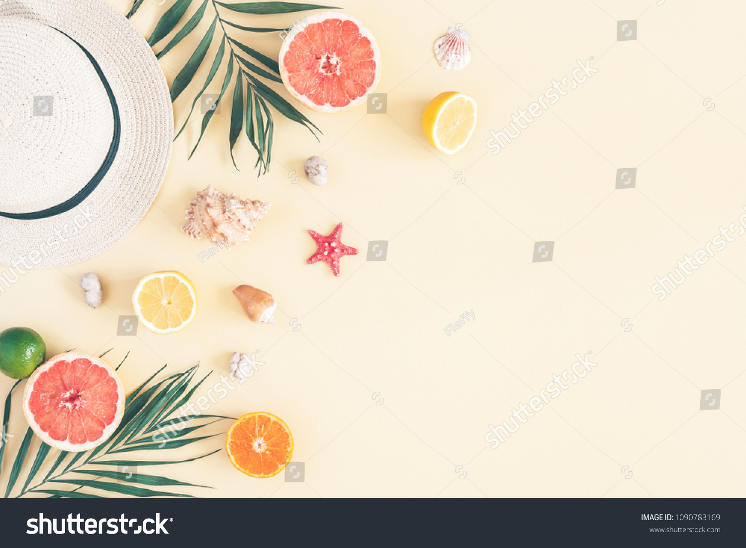 Summer composition. Fruits, hat, tropical palm leaves, seashells on pastel yellow background. Summer concept. Flat lay, top view, copy space #1090783169