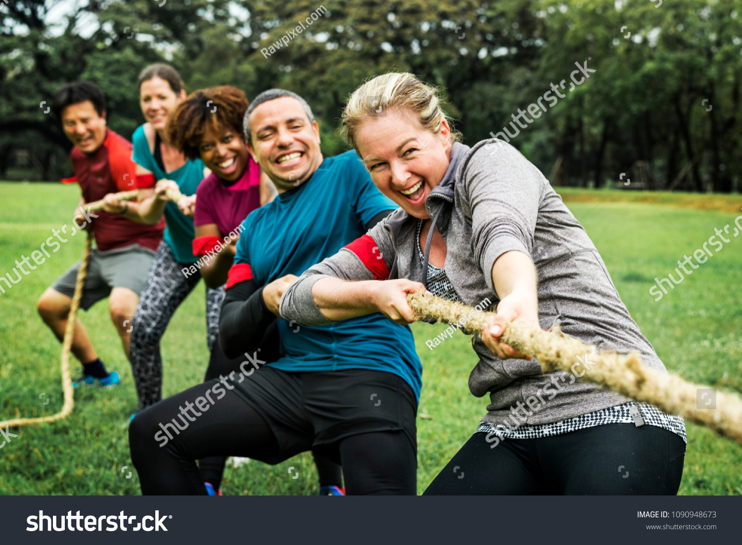 Team competing in tug of war #1090948673