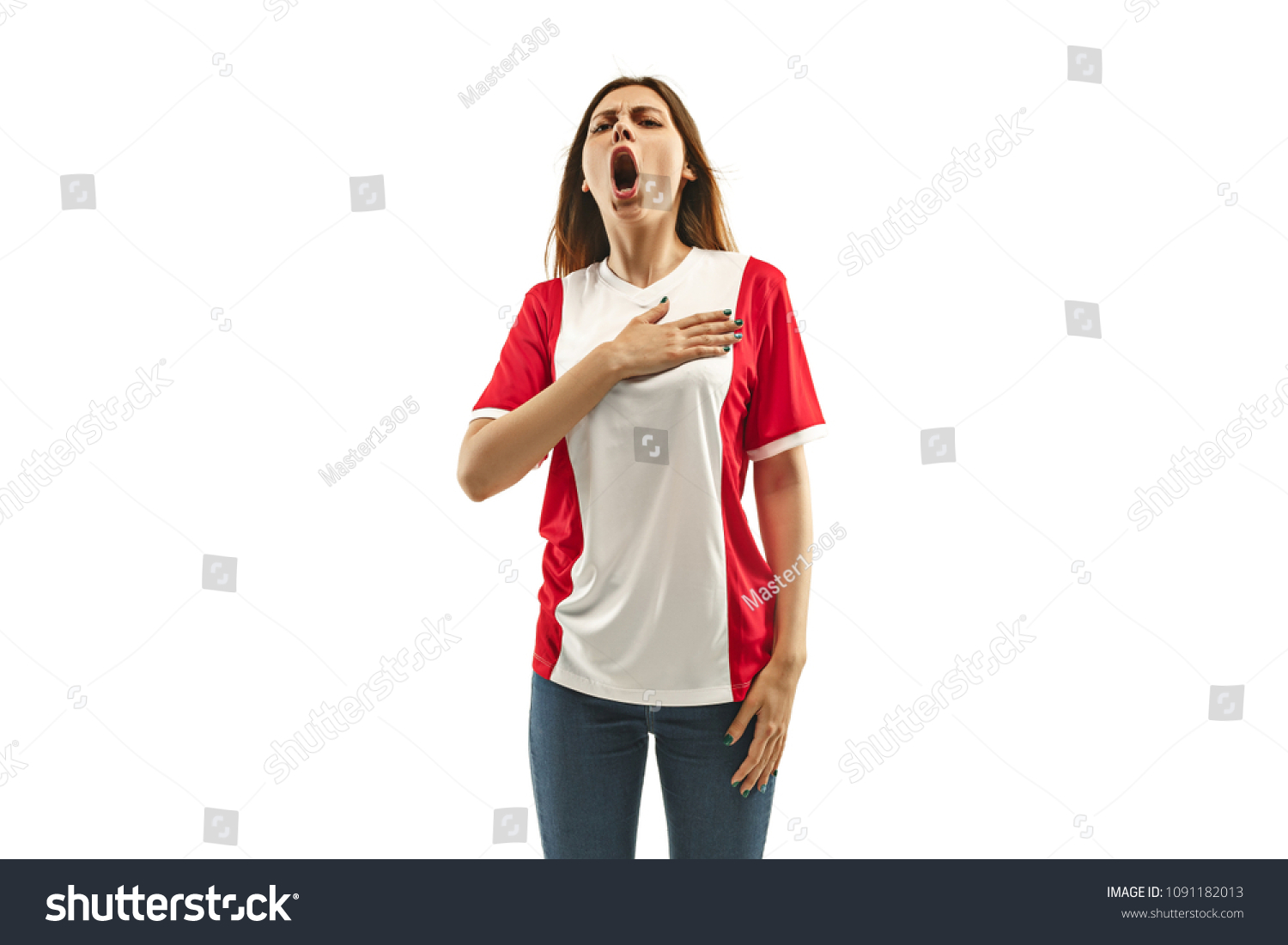 French female fan celebrating on white background. The young woman in soccer football uniform as winner standing and singing a hymn isolated at white studio. Fan, support concept. Human emotions #1091182013