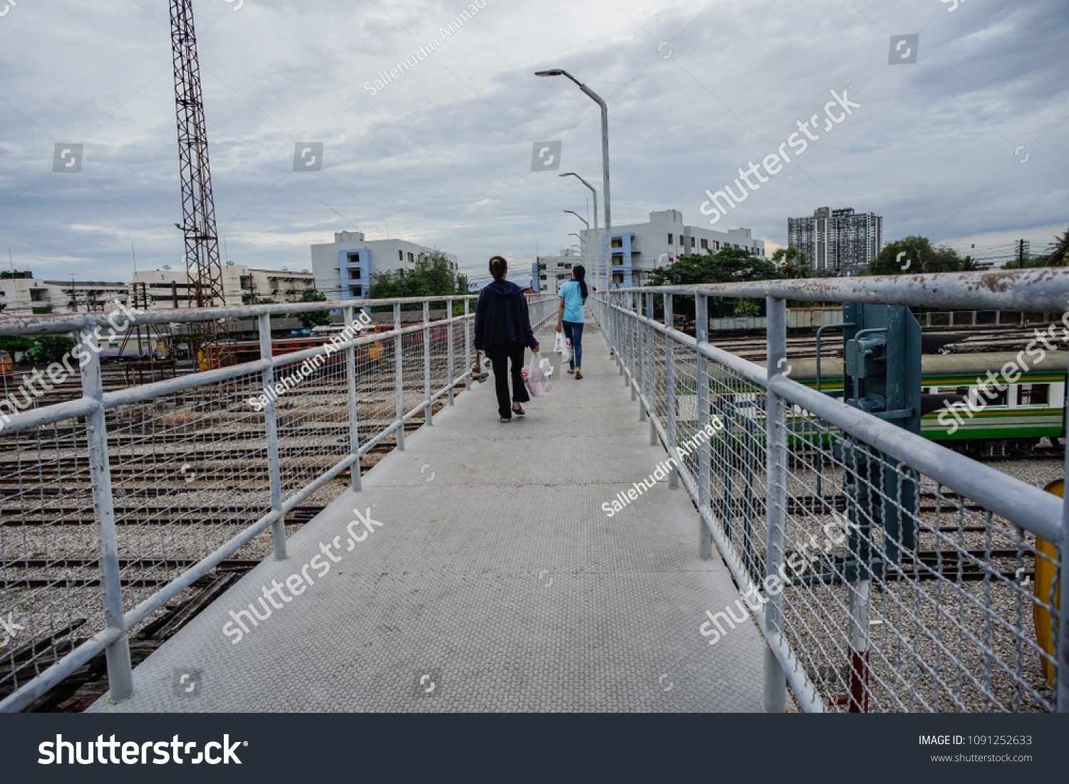 Hat-yai,Thailand - May 15 ,2018 : People using pedestrians bridge to cross a railway track at Hat Yai Train Station, Thailand. #1091252633