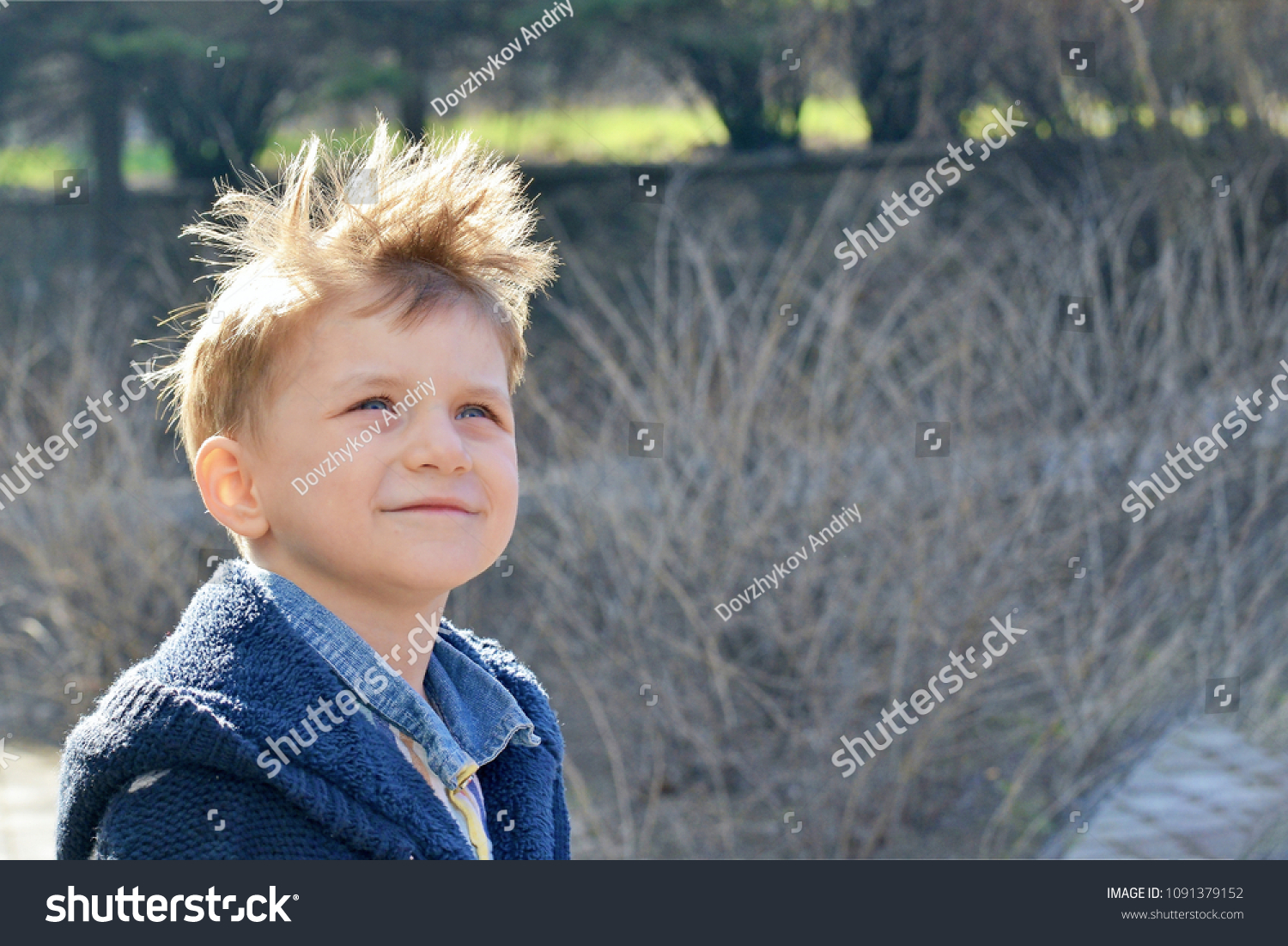 Portrait of a boy with an interesting facial expression outdoors outdoors, outdoors, child in the park. #1091379152