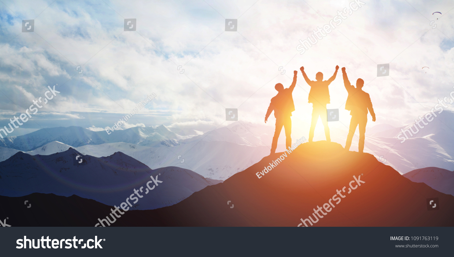 Silhouette of the team on the mountain. Leadership Concept #1091763119