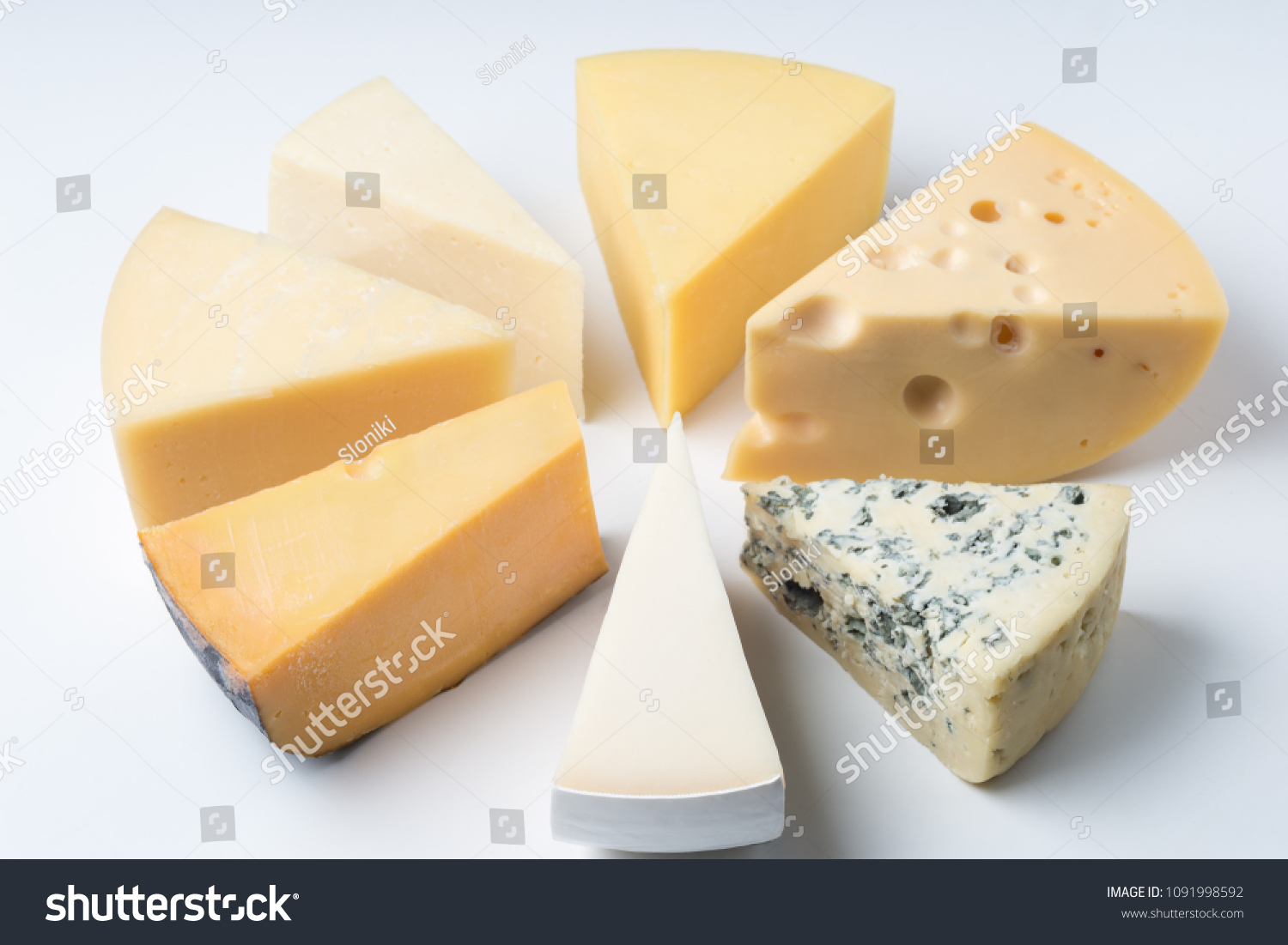 A large variety of cheeses triangles  on an white backgroud #1091998592