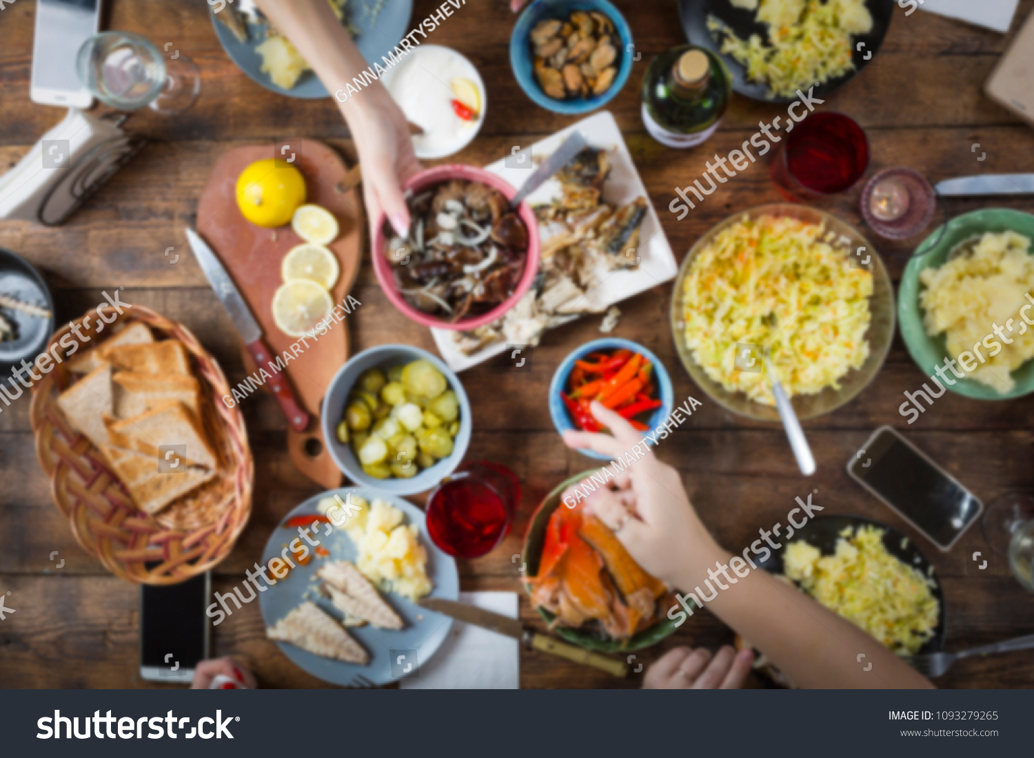 background blur. background blurred image of dinner table with different food. Easter, Christmas, Birthday, Thanksgiving. Joint toast and blow with a glass of salute in honor of the holiday. top view #1093279265