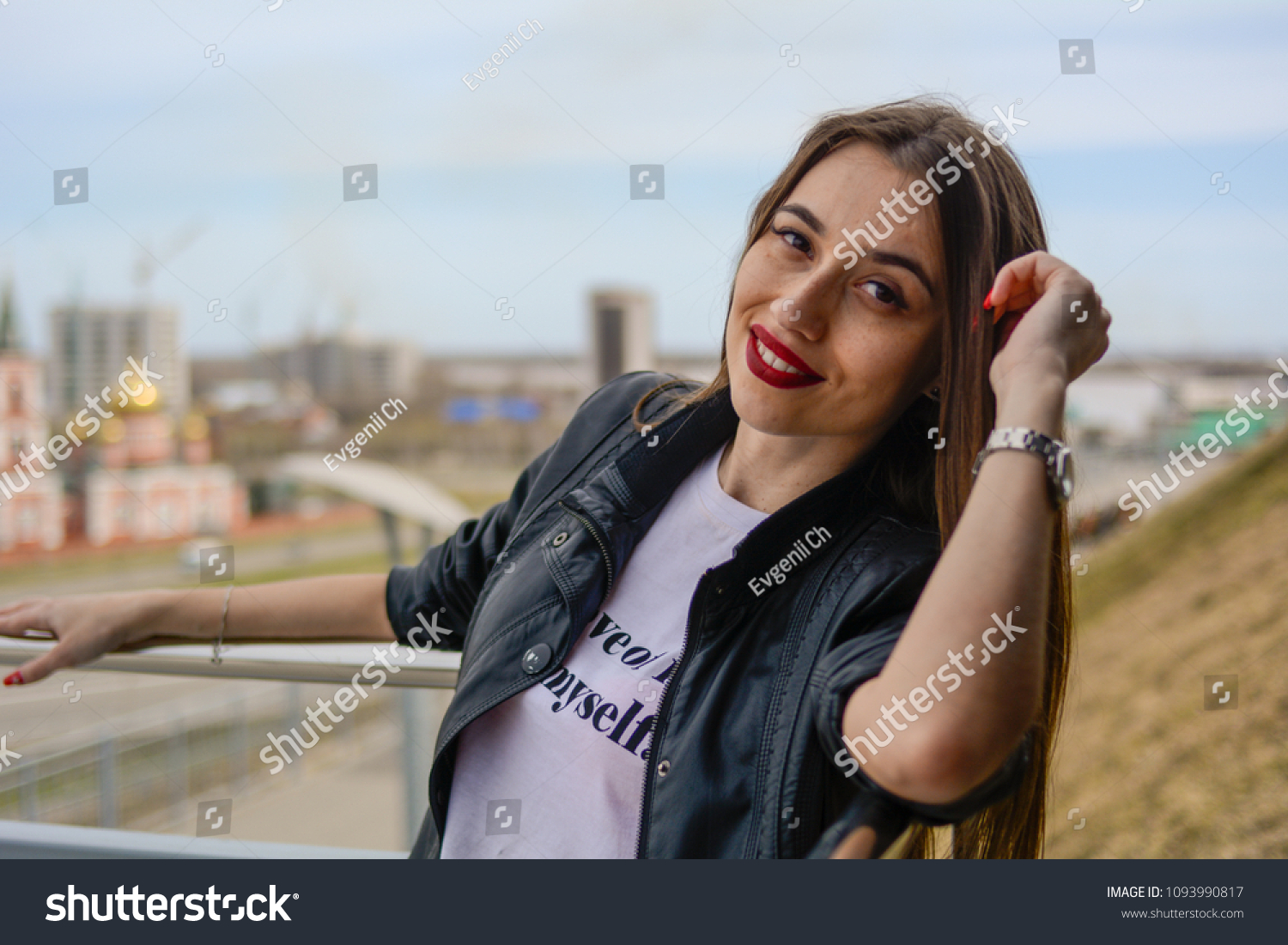 Fashionable beautiful woman in a black jacket on a summer day against the background of the city #1093990817
