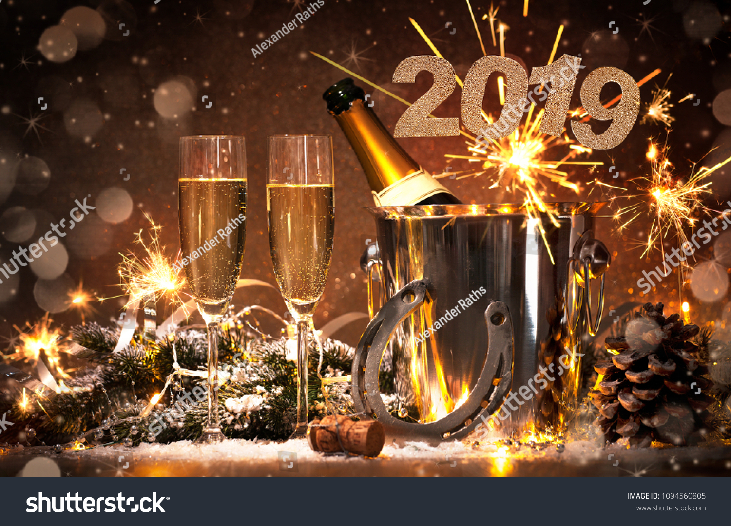 New Years Eve celebration background with pair of flutes and bottle of champagne in  bucket  and a horseshoe as lucky charm #1094560805