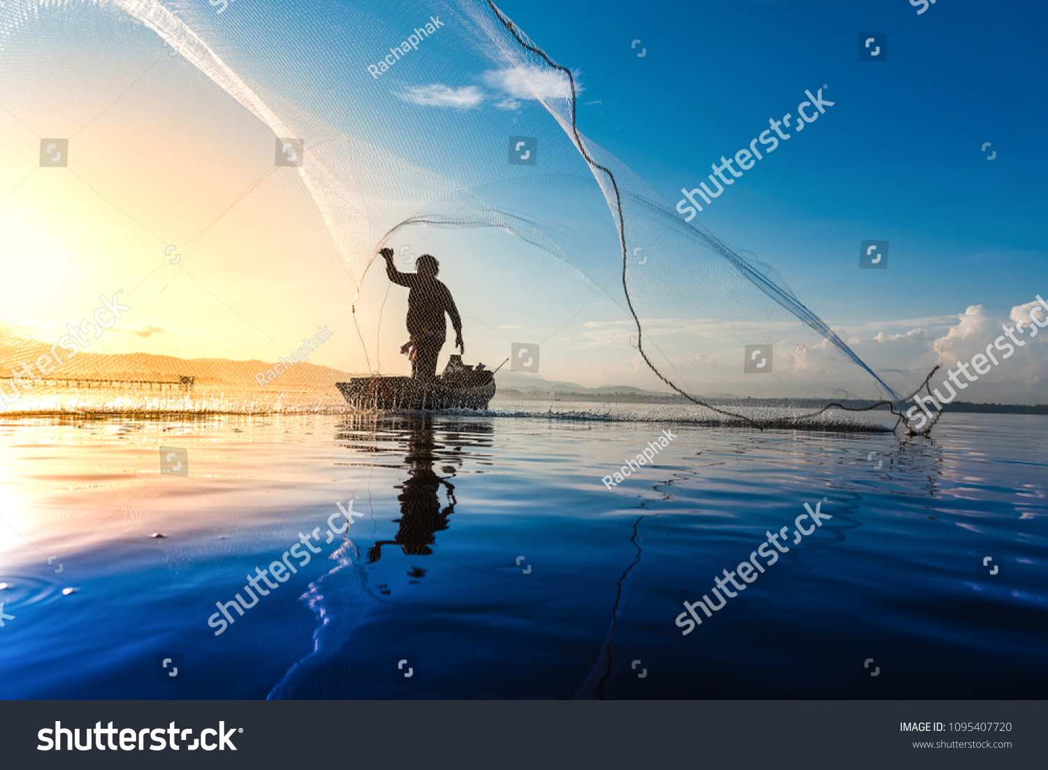 Silhouette of fishermen using coop-like trap catching fish in lake with beautiful scenery of nature morning sunrise. Beautiful scenery at Bang-Pra, Chonburi Province Thailand. #1095407720