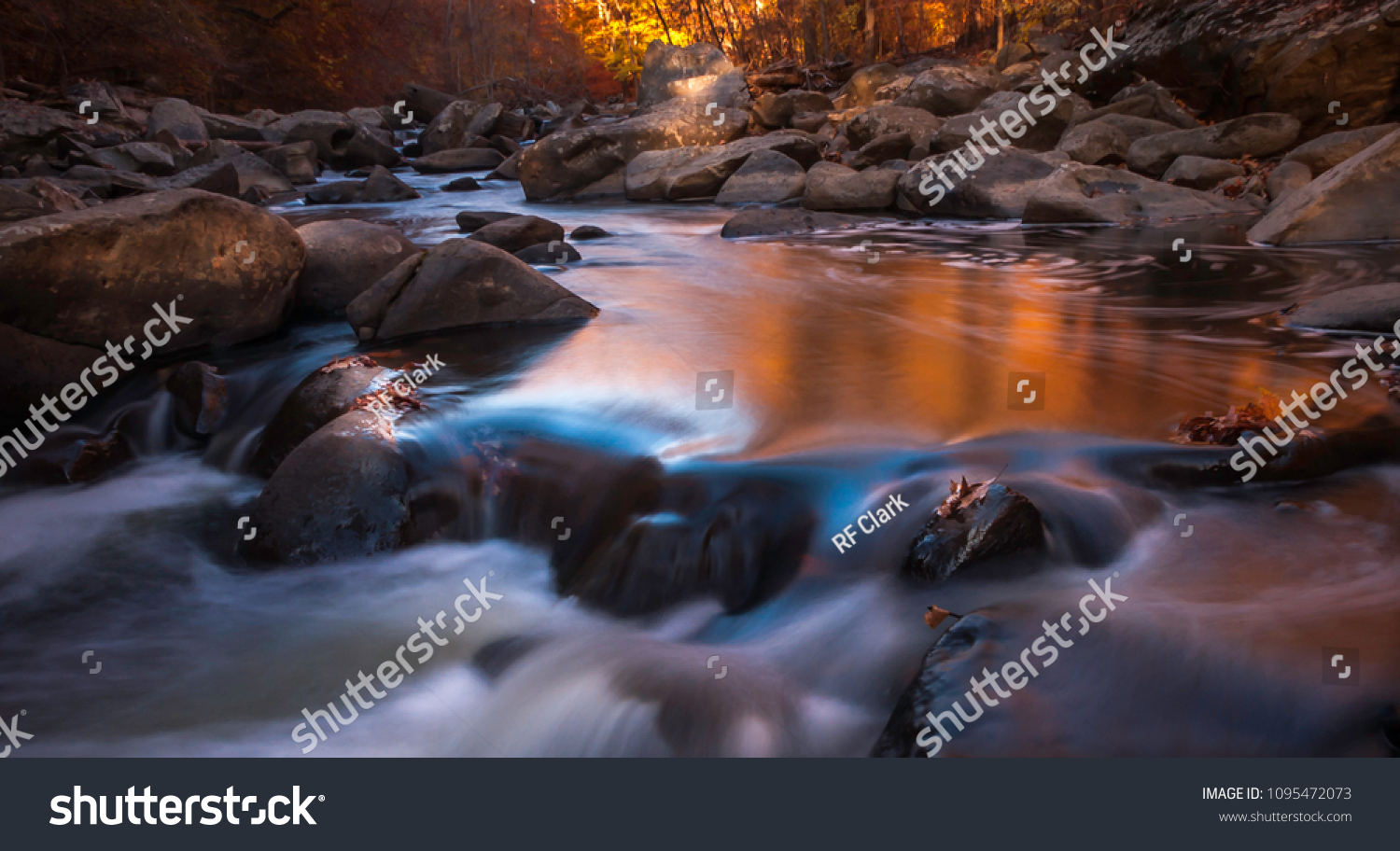 Rock Creek Pool - This long exposure image of the pool inside Rock Creek Park captures the autumn colors of orange and yellow.  It is located between Silver Spring MD and Washington DC #1095472073