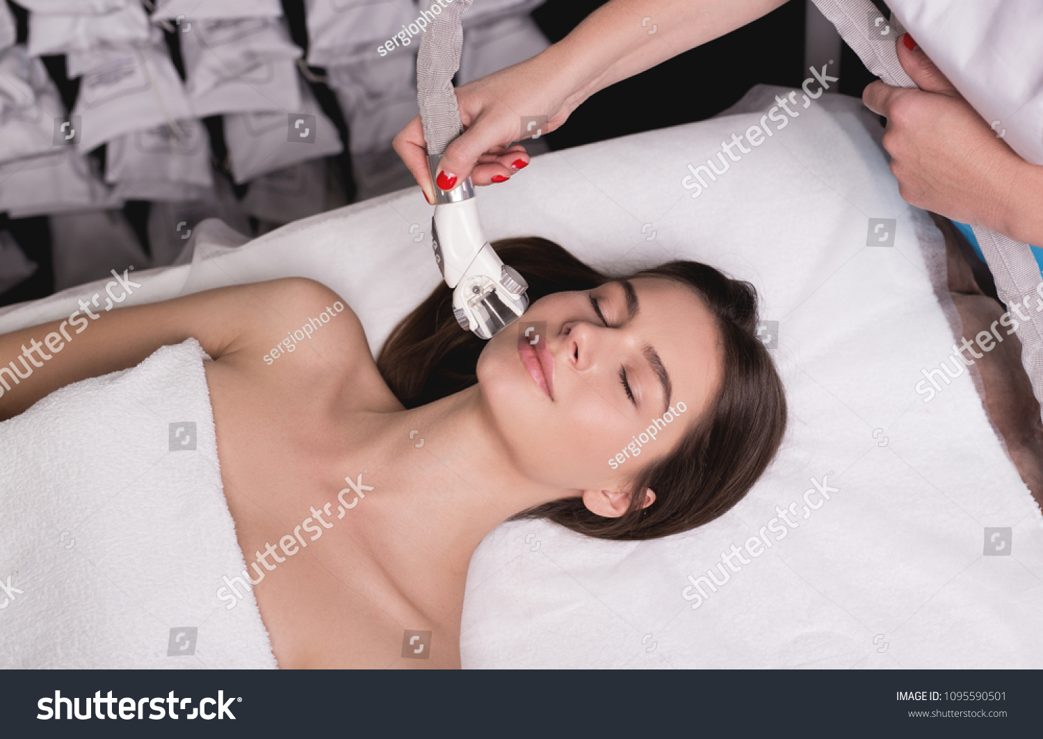 Lymphatic drainage massage LPG apparatus process. Therapist beautician makes a rejuvenating facial massage for the woman in a SPA salon. Beauty and bodycare concept. #1095590501