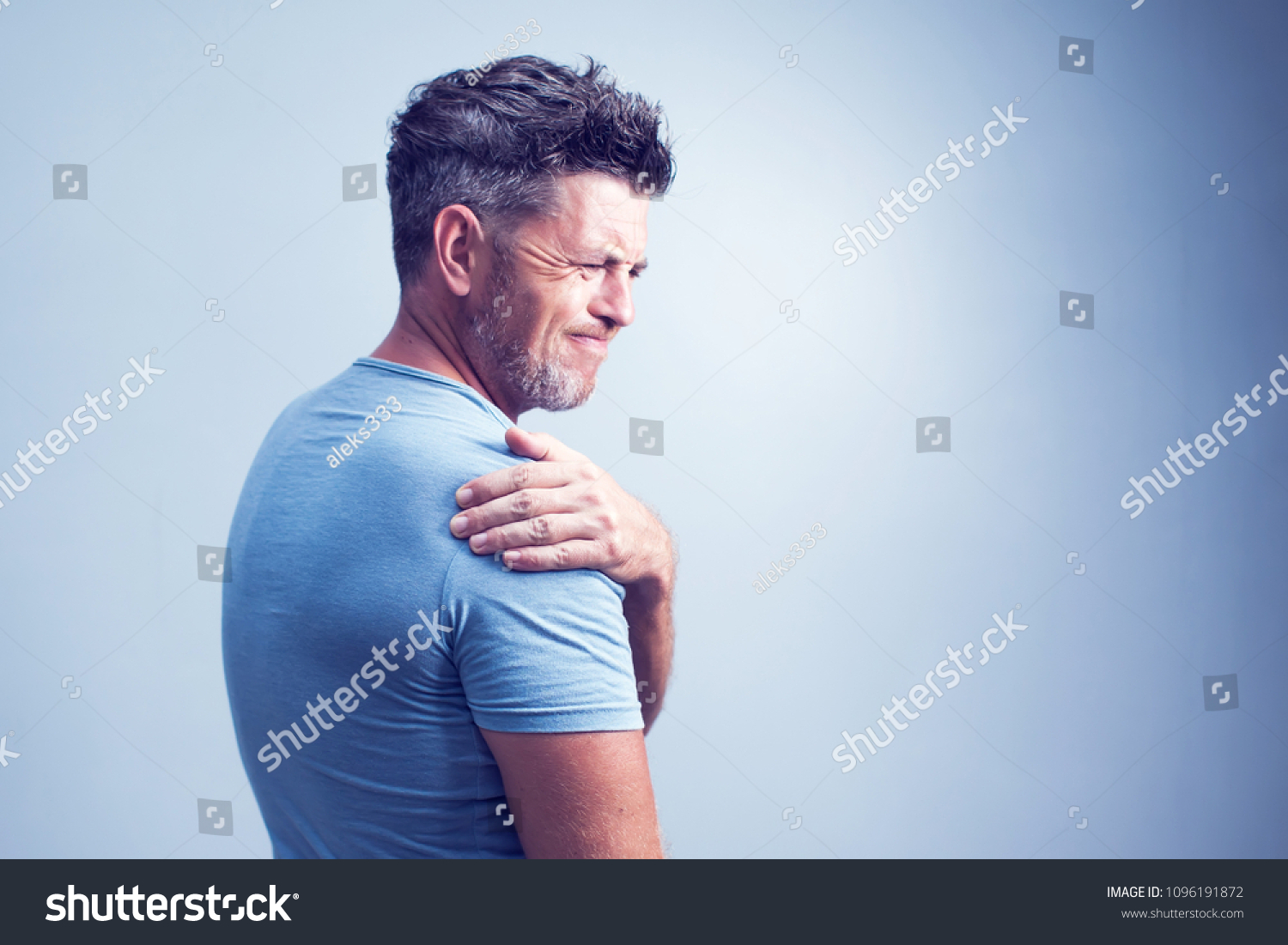 People, healthcare and problem concept - unhappy man suffering from neck or shoulder pain at home #1096191872