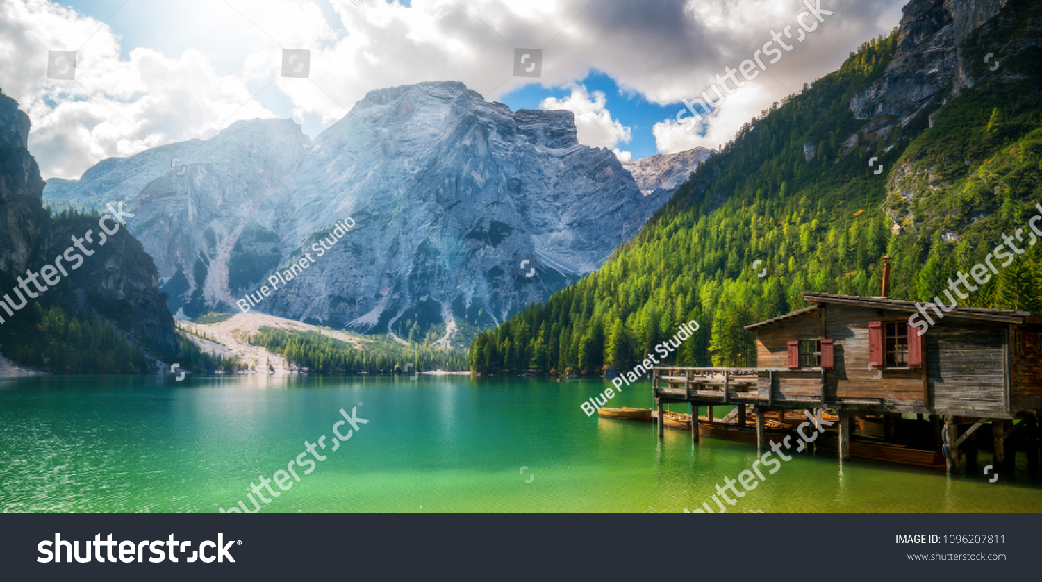 Braies Lake in Dolomites mountains forest trail in background, Sudtirol, Italy. Lake Braies is also known as Lago di Braies. The lake is surrounded by forest which are famous for scenic hiking trails. #1096207811