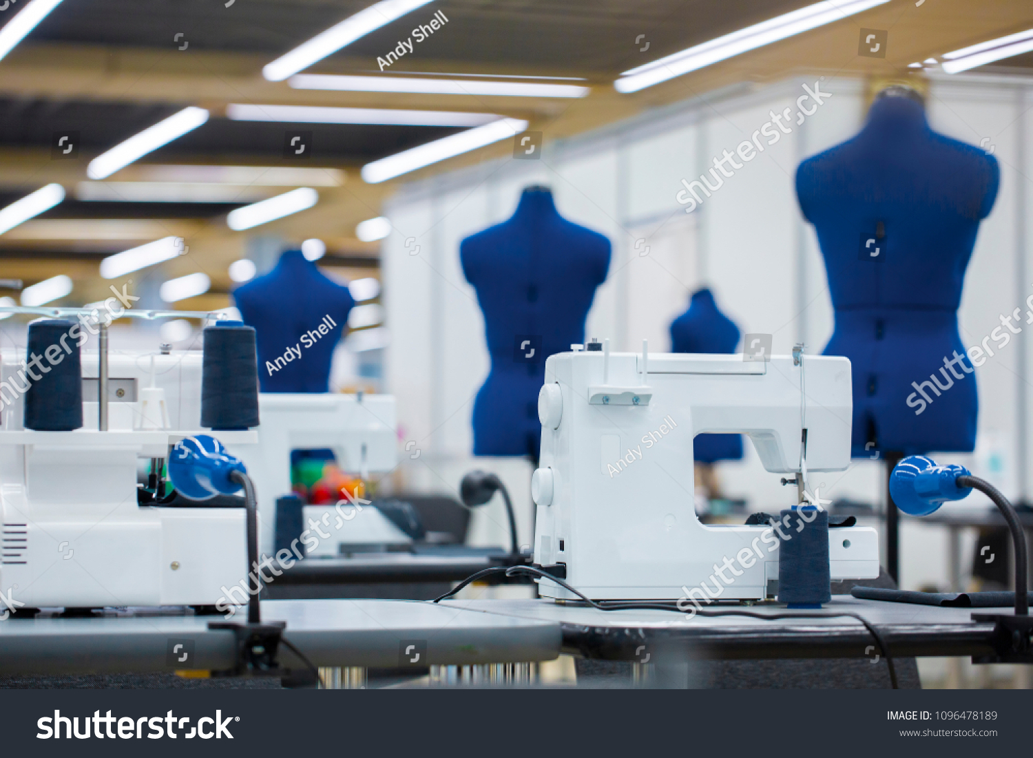 Interior of garment factory . Closes making atelier with several sewing machines. Tailoring industry, fashion designer workshop, industry concept #1096478189