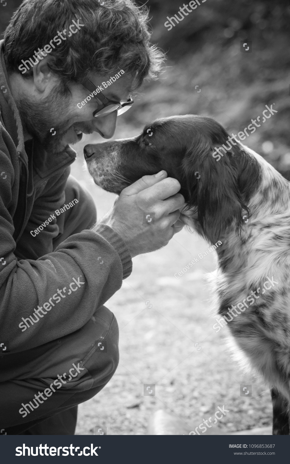 man's affection for his english setter dog in black and white #1096853687