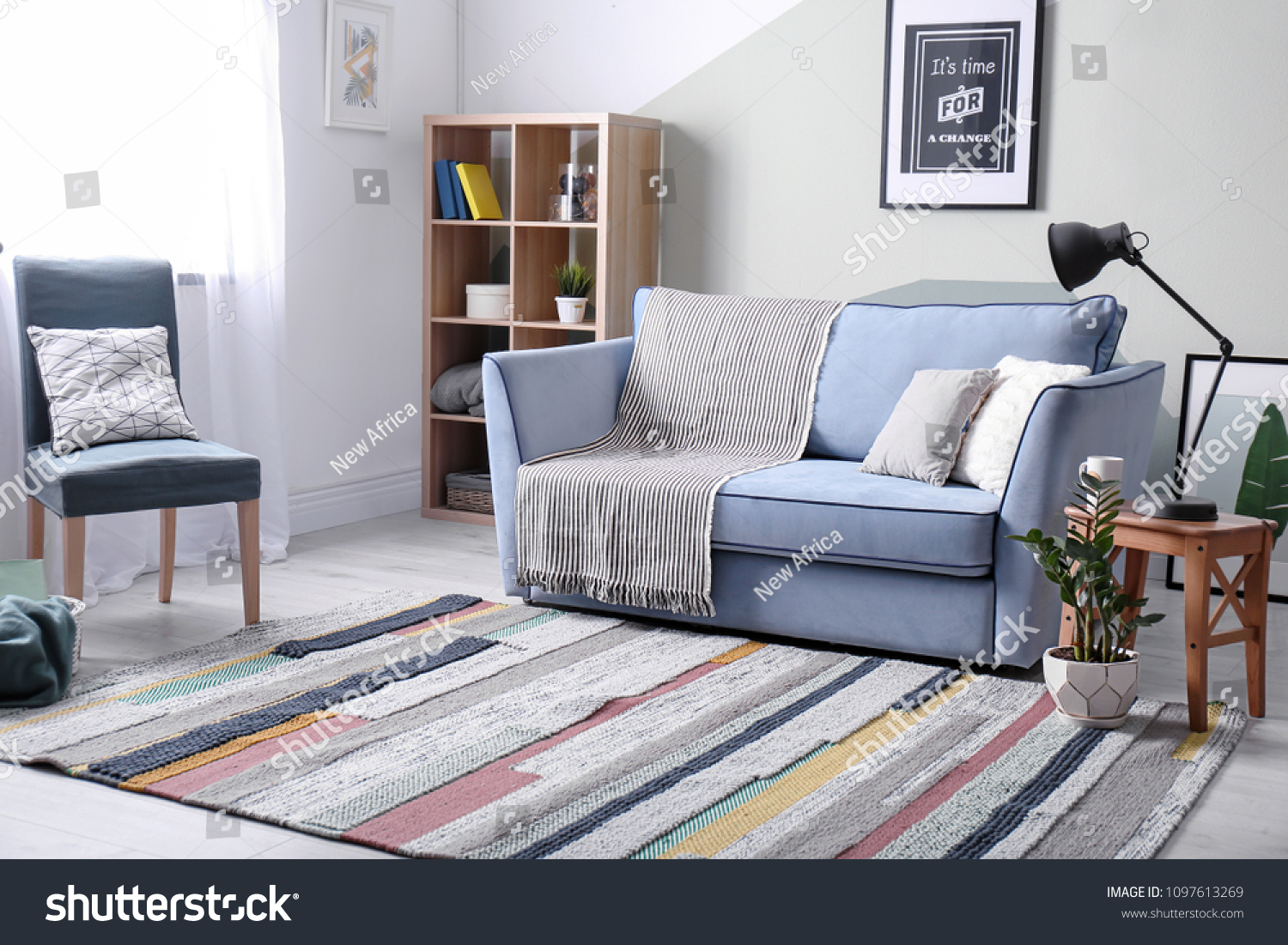 Stylish living room interior with comfortable sofa and armchair #1097613269