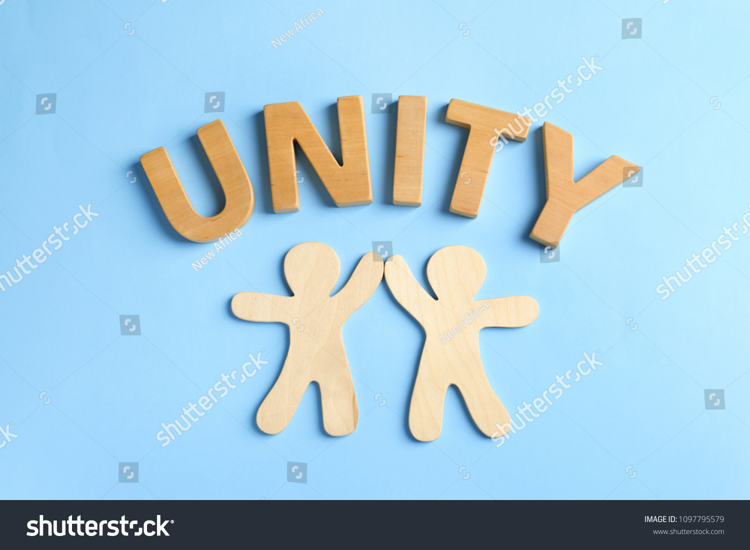 Wooden people giving high five and word UNITY on color background. Unity concept #1097795579