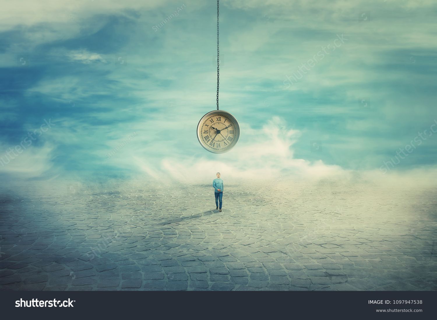 Surreal view as a man walking on a pavement road and a suspended clock on his back hanging from the sky. The importance of time in the modern world. Time travel concept. #1097947538