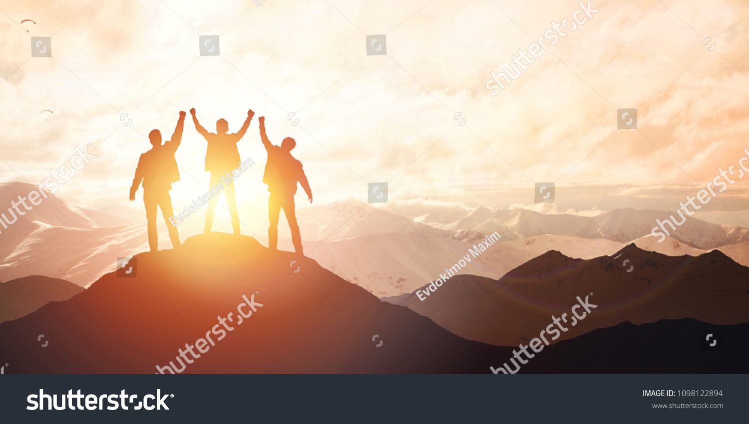 Silhouette of the team on the mountain. Leadership Concept #1098122894
