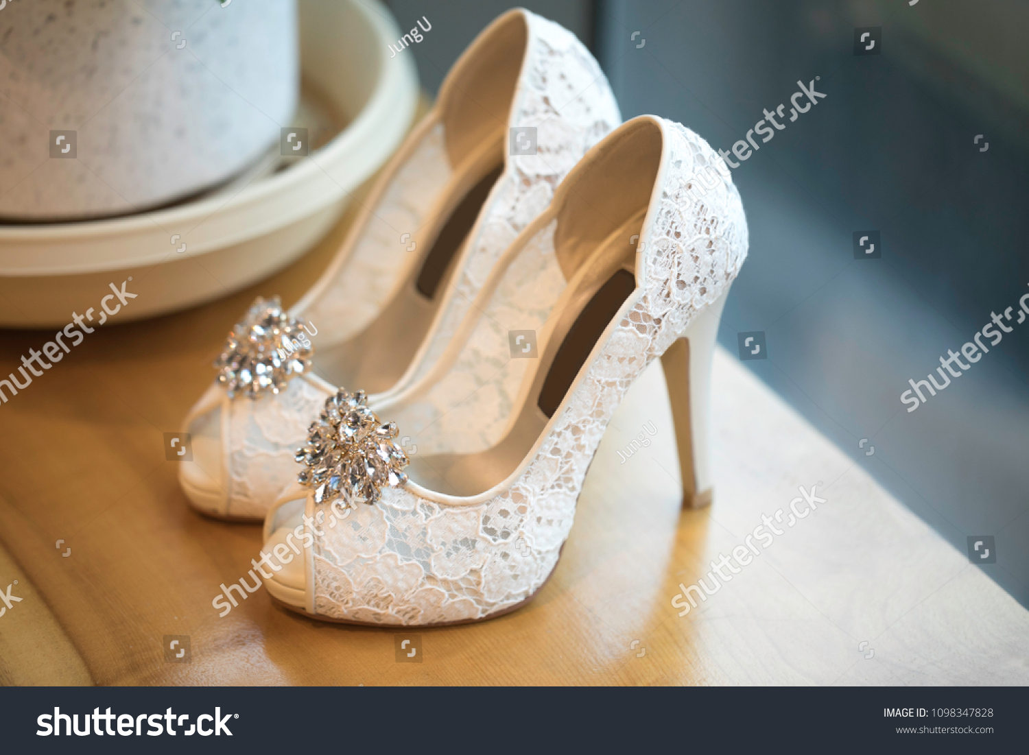 Beautiful wedding shoes in front of the window background #1098347828