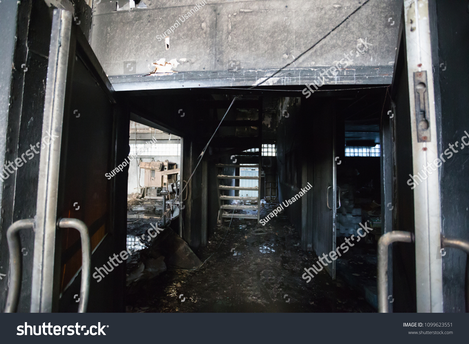 Interior of a factory damaged by fire / Damage caused by fire - Burnt interior #1099623551