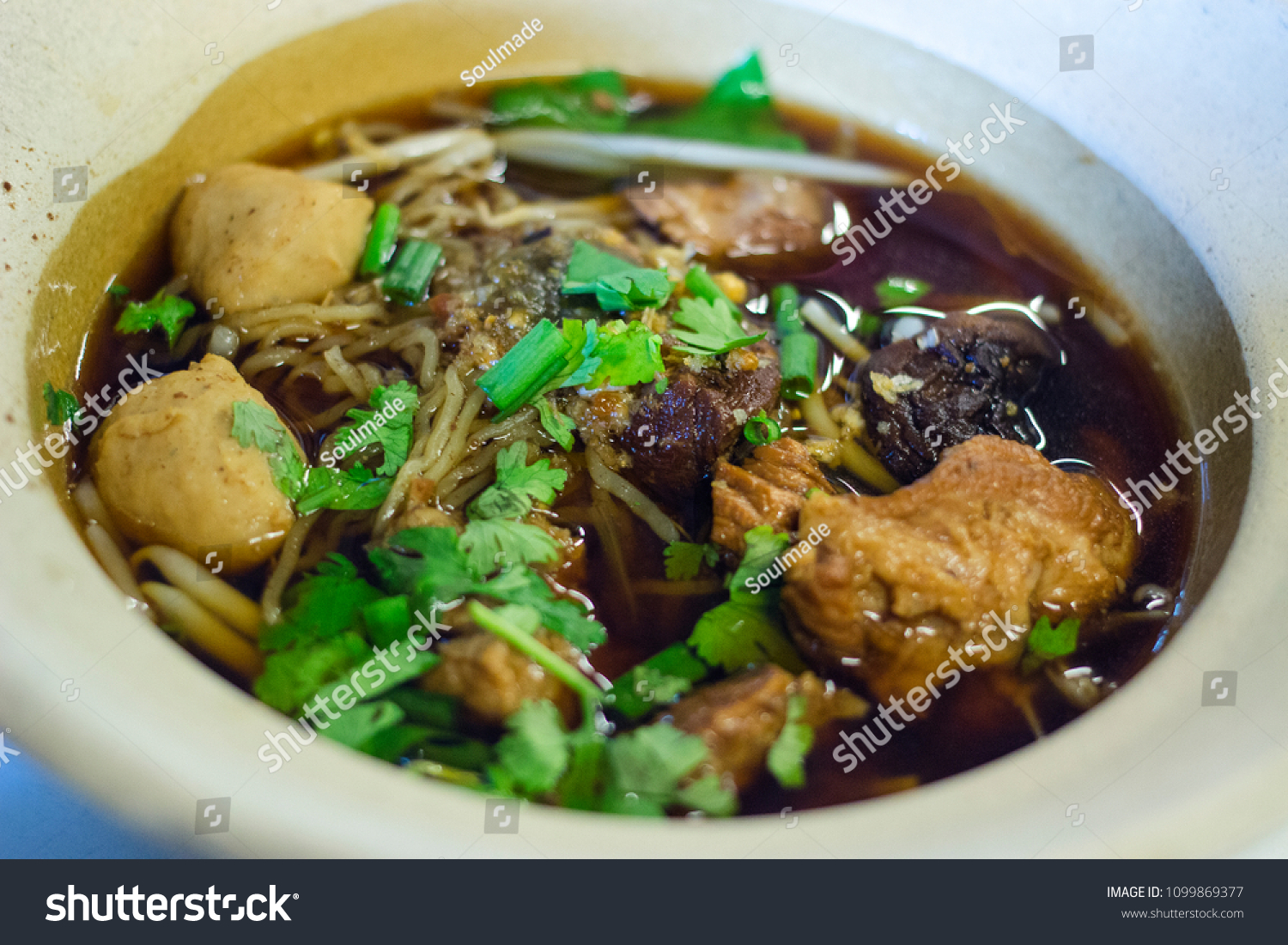 Thai Chinese Beef noodles with Mushroom Soup in the Clay Pot #1099869377