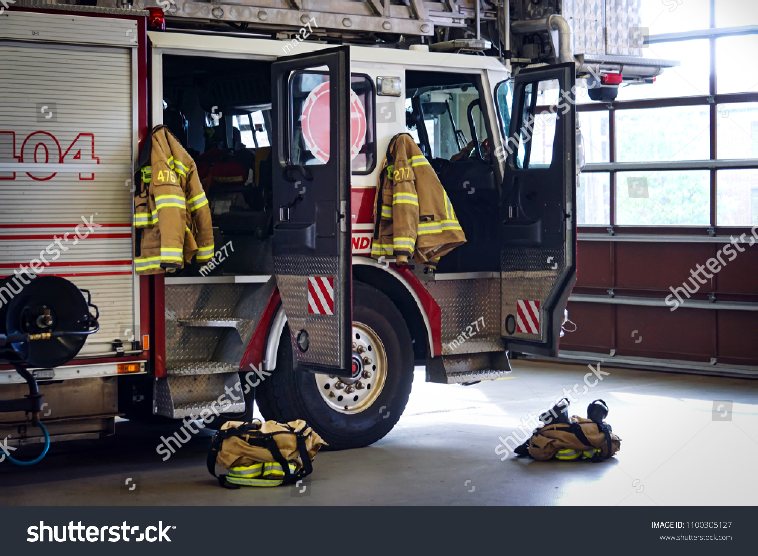 Fire truck in the firestation #1100305127