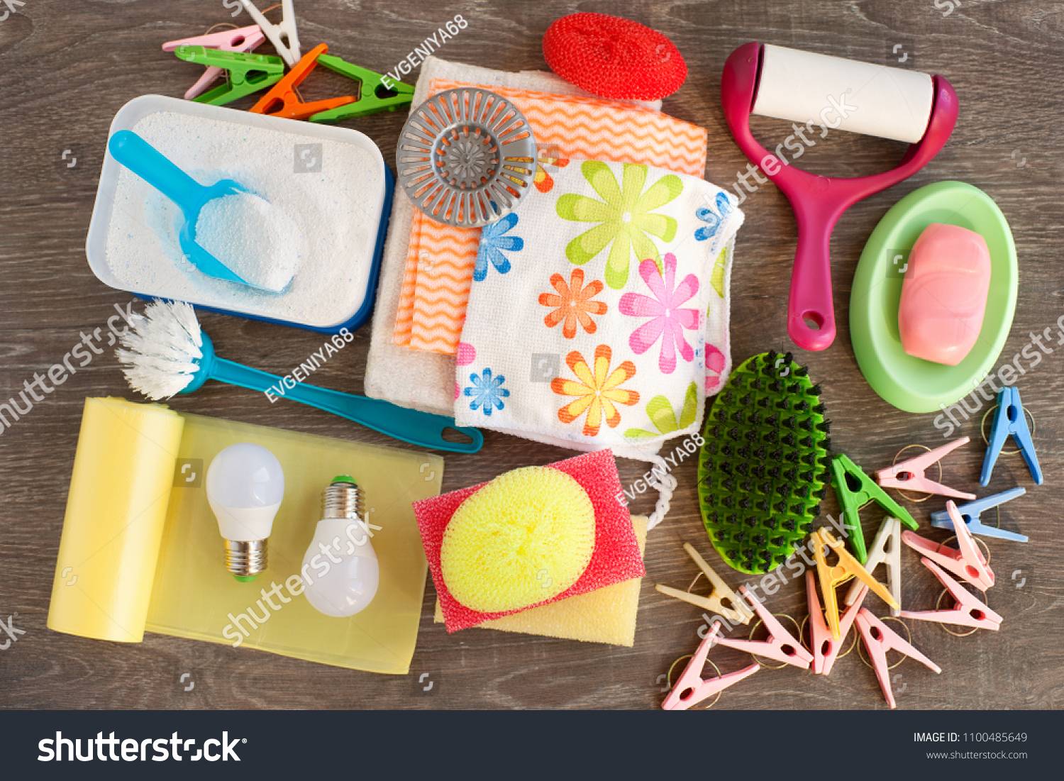 Household items of various kinds. View from above. Washing powder, garbage bags, LED lamp, clothes roller, soap and clothespins are household utensils. Household items for cleanliness in the house. #1100485649