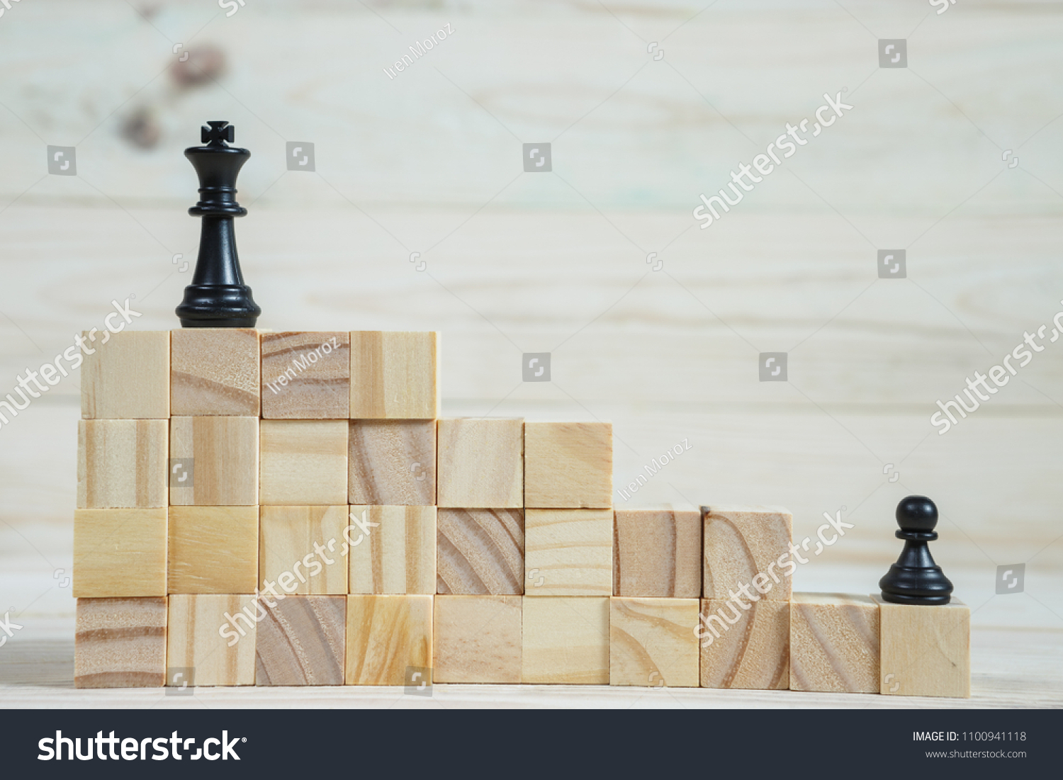 Business hierarchy. Strategy concept with chess pieces. Chess standing on a pyramid of wooden building blocks with the king at the top. copy space. #1100941118